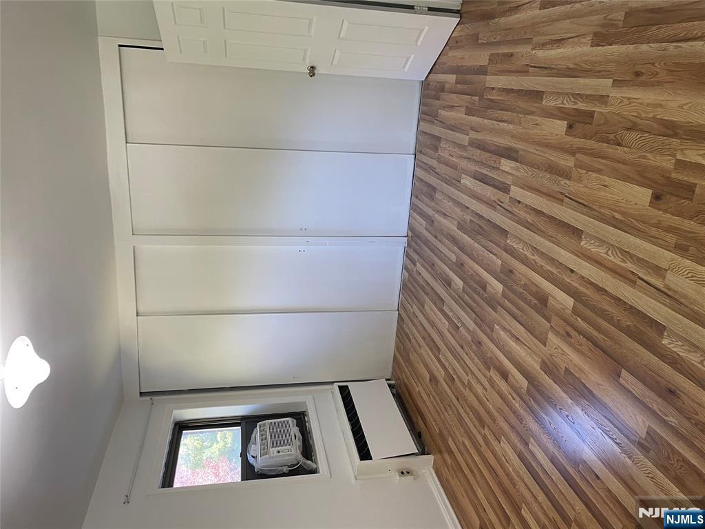 3030 Edwin Avenue, Unit 4A Fort Lee, NJ 07024 - Photo 5 of 7 a room with a bed and wooden floor