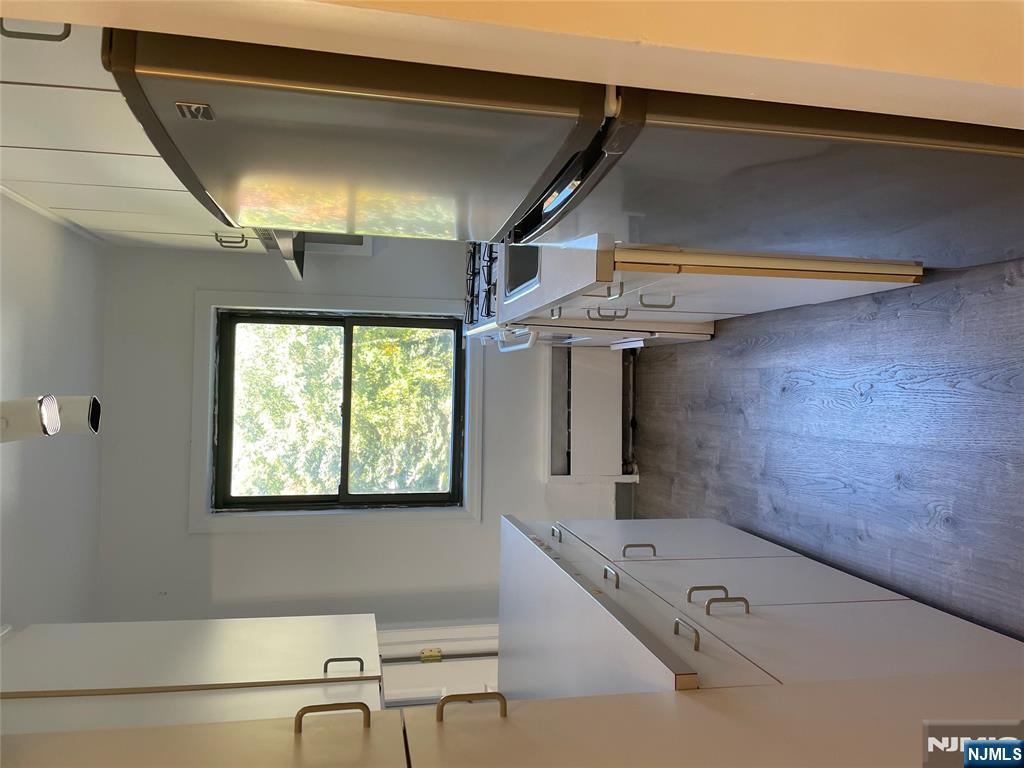 3030 Edwin Avenue, Unit 4A Fort Lee, NJ 07024 - Photo 6 of 7 a kitchen with sink a refrigerator and window