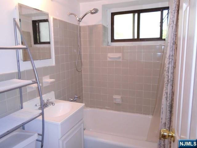 3030 Edwin Avenue, Unit 4A Fort Lee, NJ 07024 - Photo 7 of 7 a bathroom with a sink and a mirror