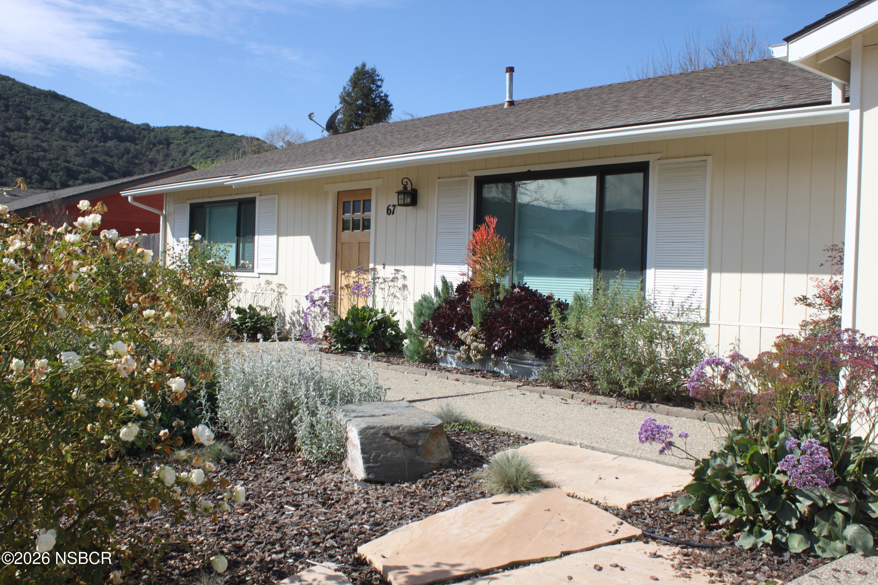 a front view of a house with garden