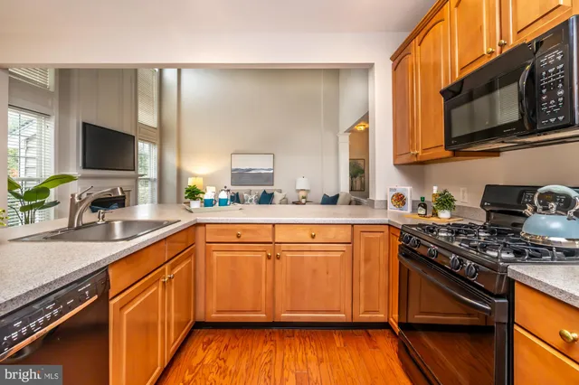 a kitchen with a sink appliances and cabinets
