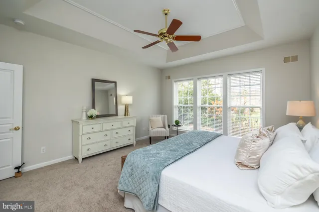a spacious bathroom with a tub shower and a sink