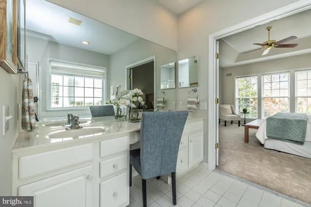 an empty room with fan and windows