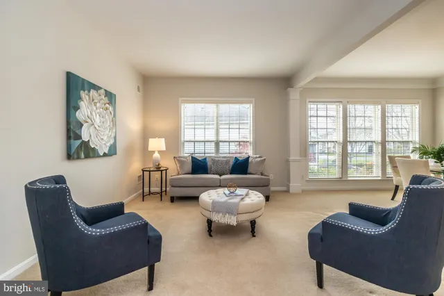 a living room with furniture and a mirror