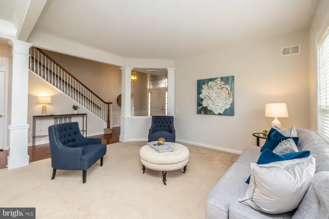 a dining room with furniture a chandelier and wooden floor