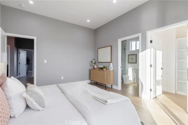 a bedroom with a bed and a mirror