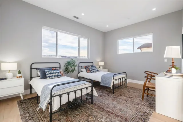 a bedroom with two beds and a table