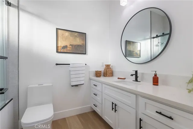 a bathroom with a toilet a sink and a mirror