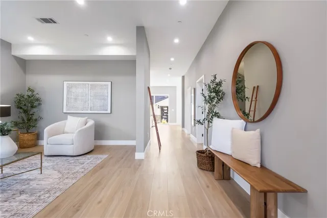 a living room with furniture and a mirror