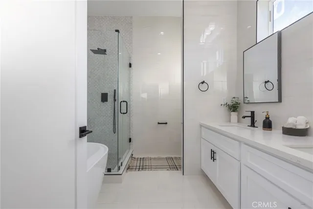 a bathroom with a shower sink and mirror