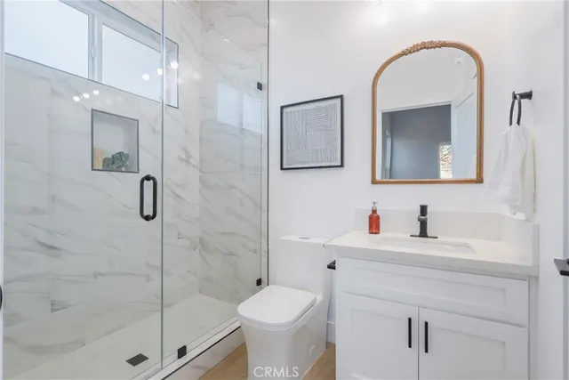 a bathroom with a toilet sink and shower