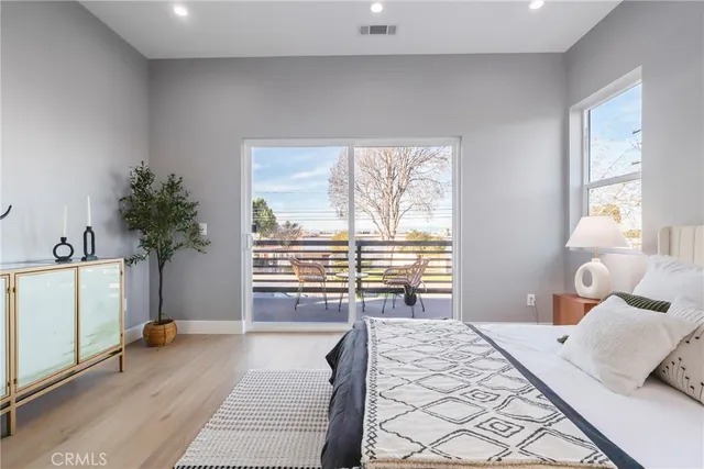 a bedroom with a large bed and a potted plant