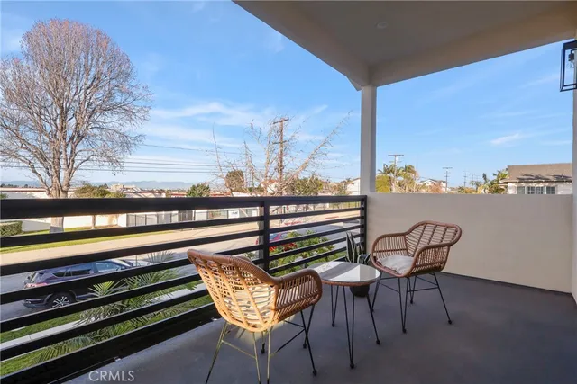 a view of a chairs and table in the balcony