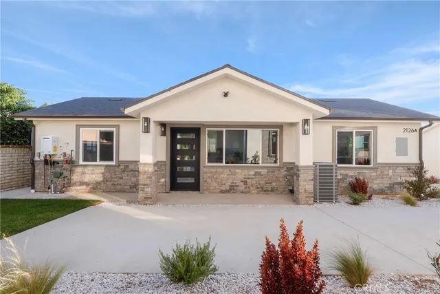 a front view of house with yard outdoor seating and barbeque oven