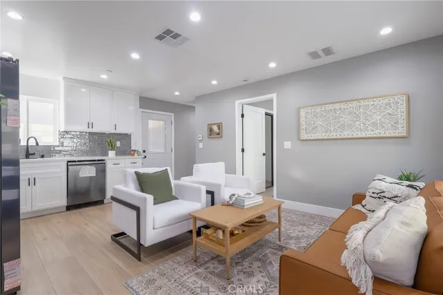 a living room with furniture and kitchen view