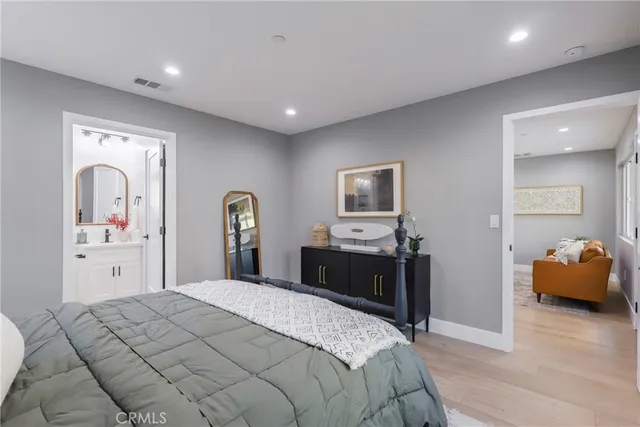 a bedroom with a bed and a mirror