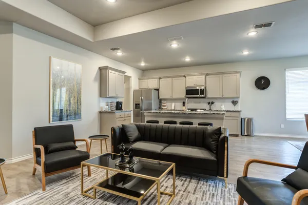 a living room with furniture and kitchen view