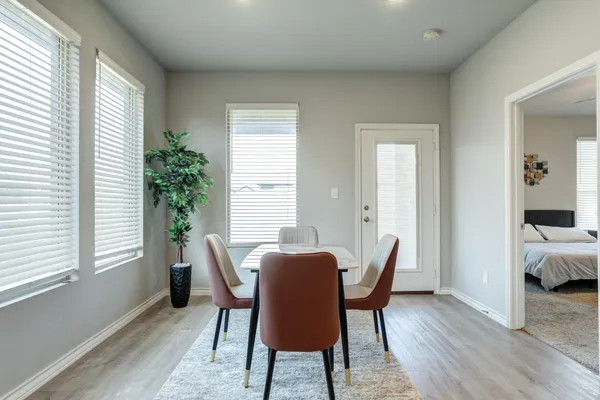 a view of a dining room with furniture and wooden floor