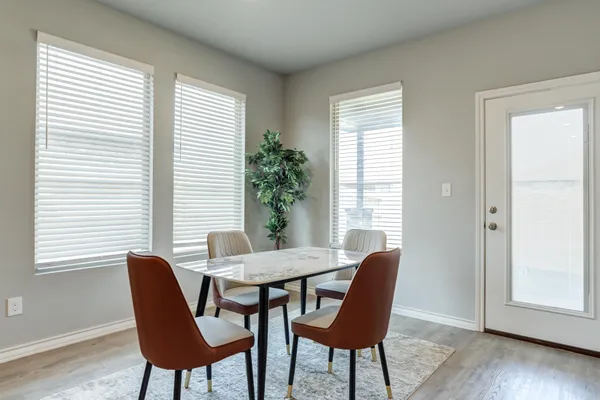a dining room with furniture and wooden floor