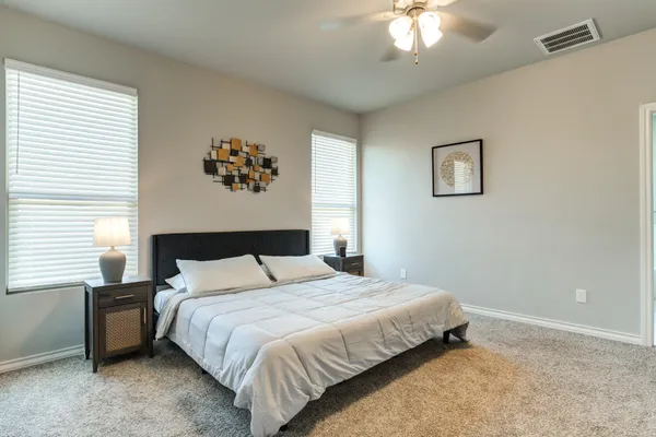 a bedroom with a bed and a chandelier