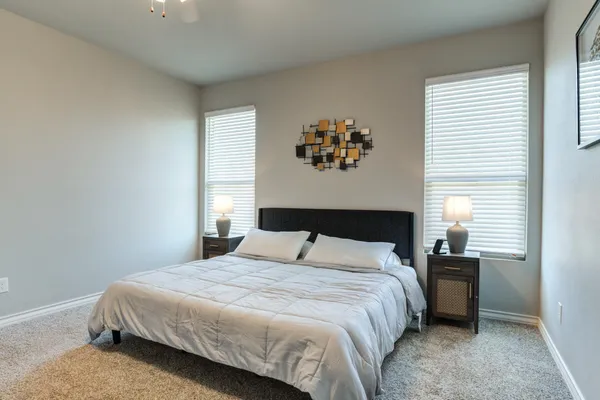 a bedroom with a large bed and a window