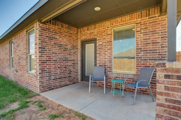 a patio with table and chairs
