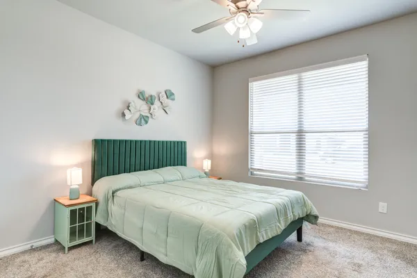 a bedroom with a bed and a chandelier