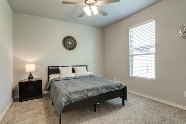a bedroom with a bed and a chandelier