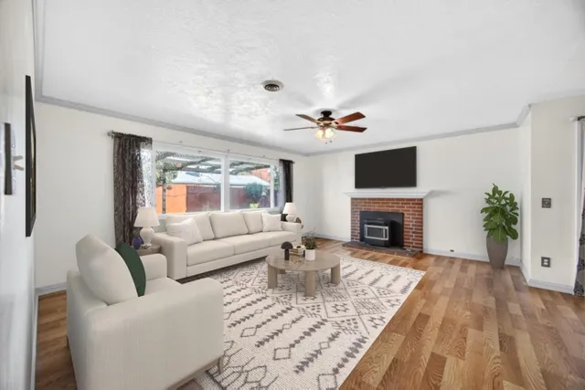 a living room with furniture a fireplace and a flat screen tv