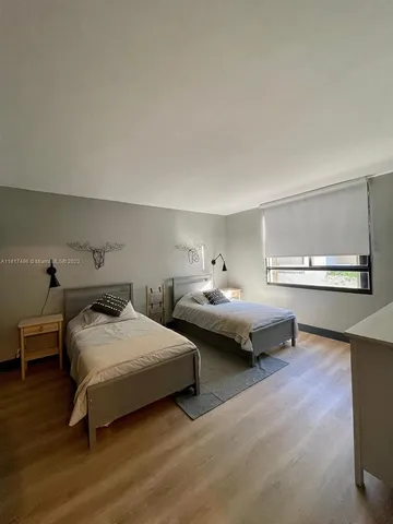 a living room with furniture a rug and a window