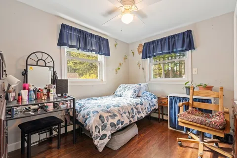 a bedroom with bed and a window