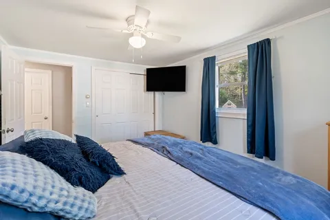 a bedroom with a large bed and a window