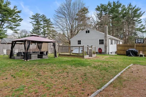 a view of a house with a yard and sitting area