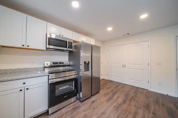 a kitchen with stainless steel appliances a stove microwave and sink
