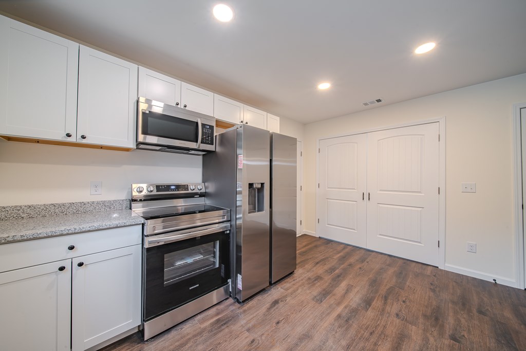 4384 Forrest Road Columbus, GA 31907 - Photo 13 of 30 a kitchen with stainless steel appliances a stove microwave and sink