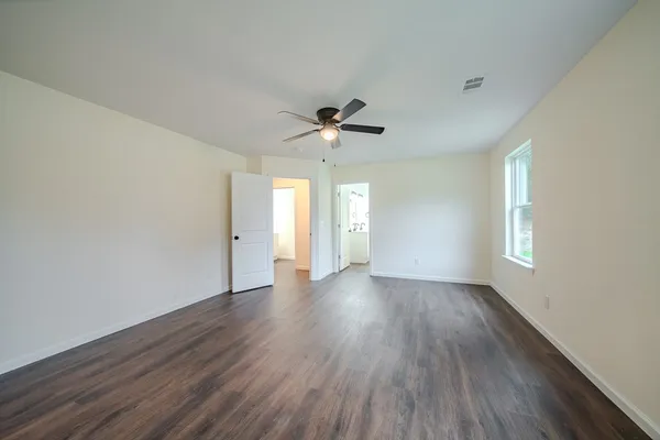 wooden floor in an empty room with a window