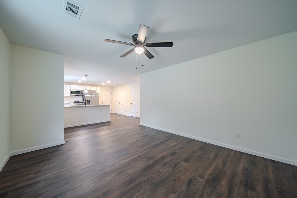 4384 Forrest Road Columbus, GA 31907 - Photo 6 of 30 an empty room with wooden floor ceiling fan and windows