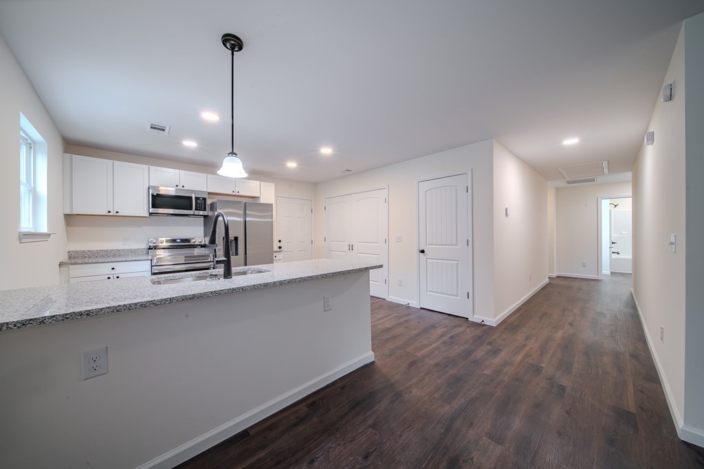 4384 Forrest Road Columbus, GA 31907 - Photo 9 of 30 a large kitchen with stainless steel appliances a large counter top a sink a refrigerator and a window