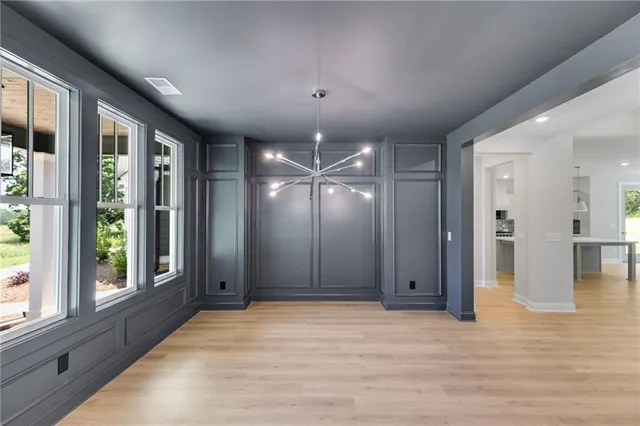 a kitchen with kitchen island a stove a refrigerator and a counter top space