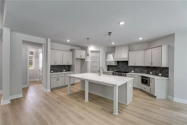 a kitchen with white cabinets and appliances