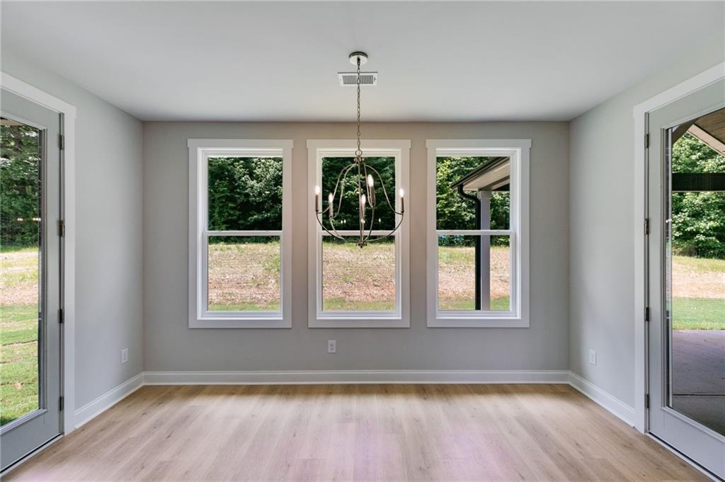 662 Lake Cir Road Buchanan, GA 30113 - Photo 20 of 62 a view of an empty room with wooden floor and a window