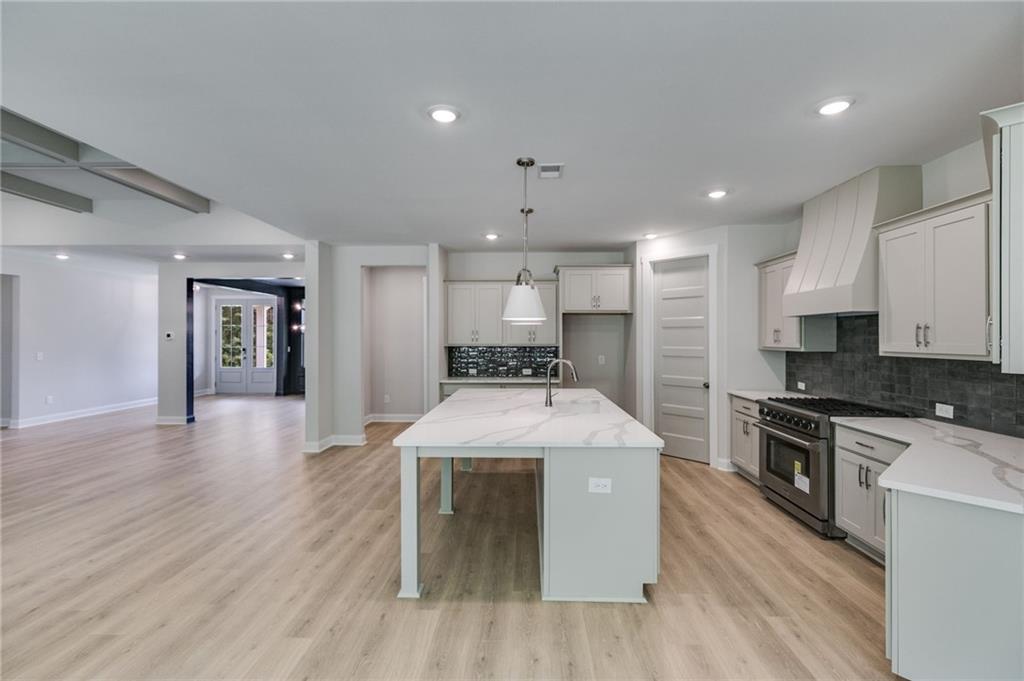 662 Lake Cir Road Buchanan, GA 30113 - Photo 22 of 62 a large kitchen with stainless steel appliances granite countertop a stove a sink dishwasher and a refrigerator with wooden floor