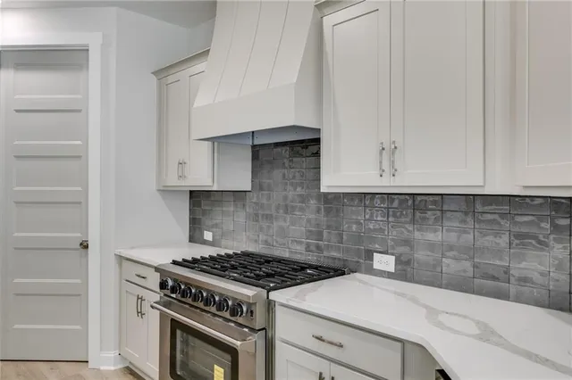 a view of hallway with closet and wooden floor