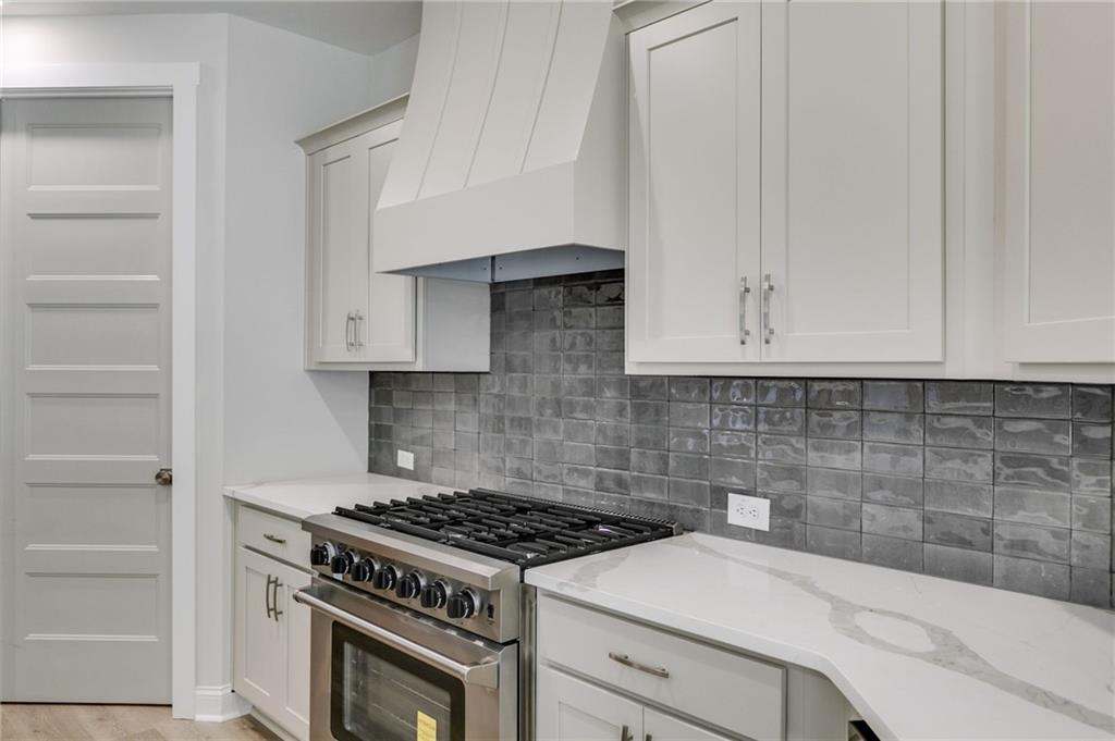 662 Lake Cir Road Buchanan, GA 30113 - Photo 23 of 62 a kitchen with white cabinets and appliances