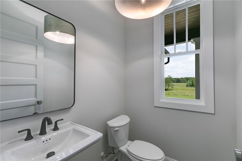 662 Lake Cir Road Buchanan, GA 30113 - Photo 26 of 62 a bathroom with a toilet sink and mirror
