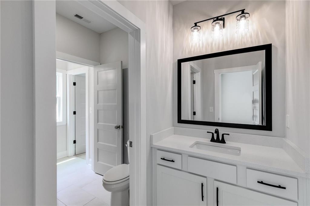 662 Lake Cir Road Buchanan, GA 30113 - Photo 32 of 62 a bathroom with a toilet sink double and mirror