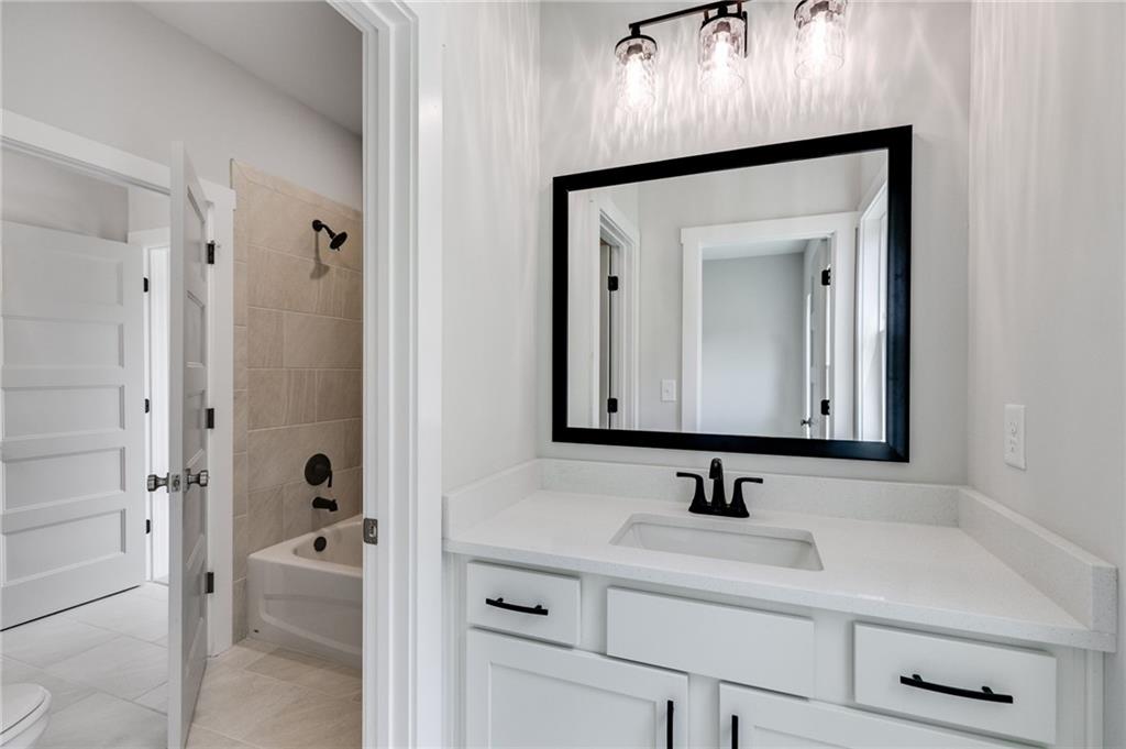 662 Lake Cir Road Buchanan, GA 30113 - Photo 33 of 62 a bathroom with a sink a toilet and a large mirror