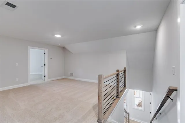 an empty room with fan and entrance