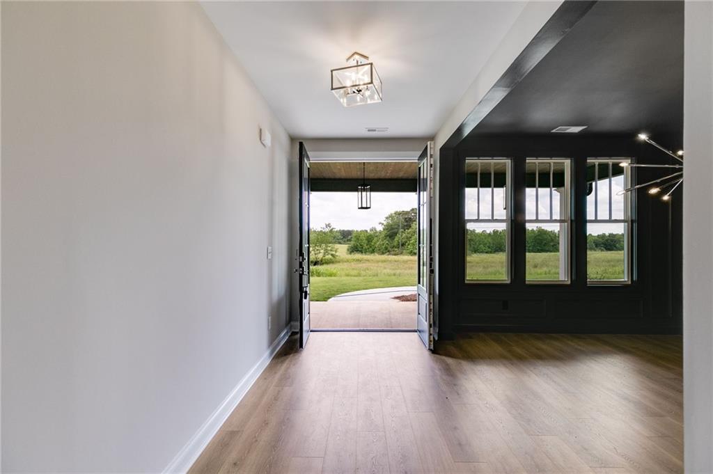 662 Lake Cir Road Buchanan, GA 30113 - Photo 44 of 62 wooden floor in an empty room with a window