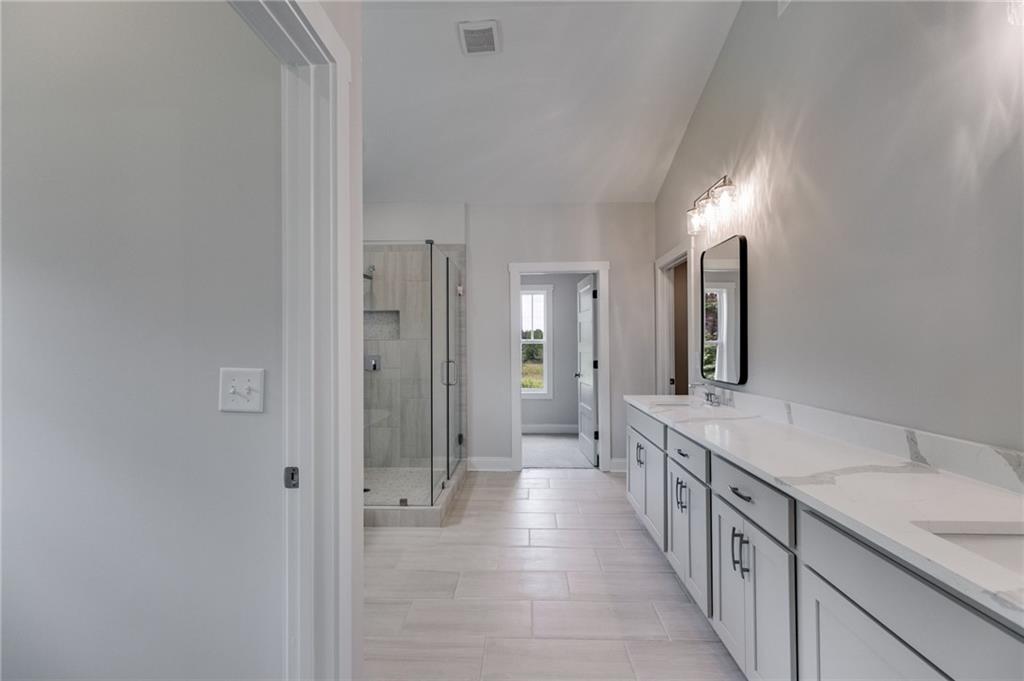 662 Lake Cir Road Buchanan, GA 30113 - Photo 48 of 62 a bathroom with a double vanity sink and a mirror
